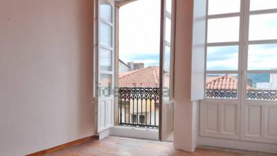 Dormitorio y balcón de un apartamento de 33 metros cuadrados en la Rúa do Vilar, con un precio de 125.000 euros