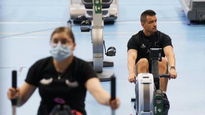 Dos personas, una de ellas proteginas con mascarilla, realizan ejercicio en un gimnasio de Santiago FOTO: Álvaro Ballesteros