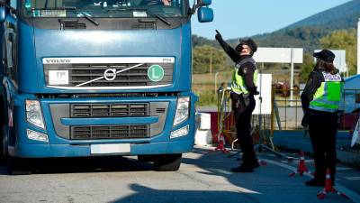 Un agente da el alto a un camión en un punto fronterizo entre España y Portugal. Foto: Gustavo Valiente / E.P.