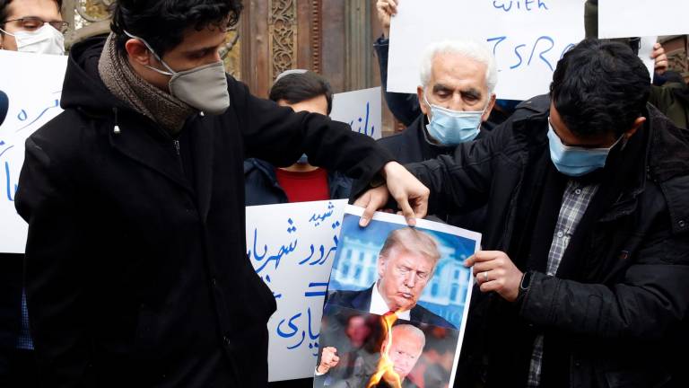 Iraníes queman fotos de Trump y Biden. Foto: A. Taherkenareh/Efe