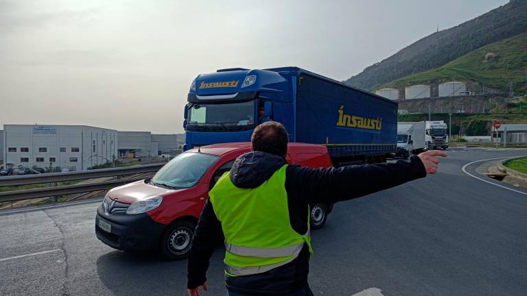 Un piquete informativo señaliza con la mano para tratar de impedir la entrada de un camión al Puerto de Bilbao. EUROPA PRESS 28/03/2022