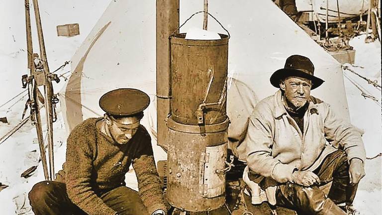 Frank Hurley (a la izquierda), fotógrafo de la expedición, junto a Ernest Shackleton, en una cocina de campaña sobre la planicie heleda de Ocean Camp . Octubre de 1915.