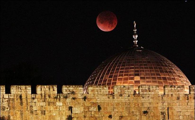 La Ciudad Vieja de Jerusalén recibió las primeras horas del día con la luna pintada de rojo. En la imagen se puede ver como la Cúpula de la Roca, lugar sagrado para el Islam, se tiñe del color rojo del satélite. (Fuente, bbc.co.uk)