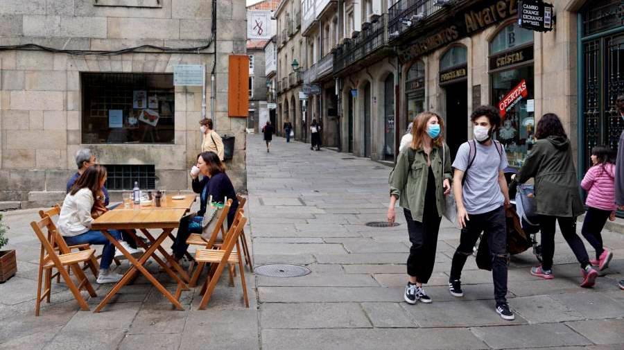 Gente paseando y en una de las terrazas de una cafetería en las calles de Santiago. F. BLANCO