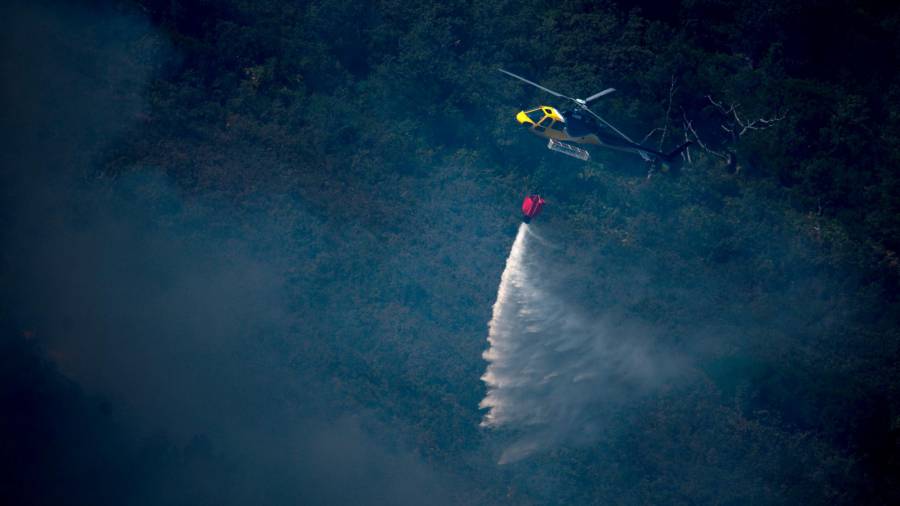 Un helicóptero lanzando una carga de agua sobre los montes de Lobios. Foto: Brais Lorenzo