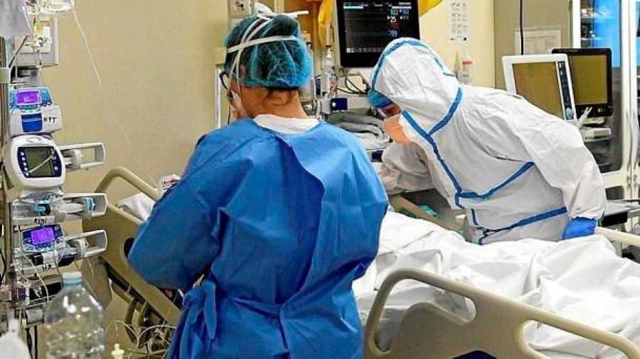 Un médico y una enfermera atienden a paciente con covid-19 en una Unidad de Cuidados Intensivos Foto: Efe