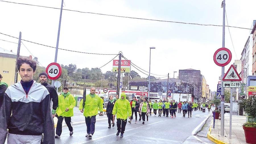 ruta urbana. Participantes en la andaina contra el cáncer a su paso por la calle Principal de Boiro. Foto: C.B.