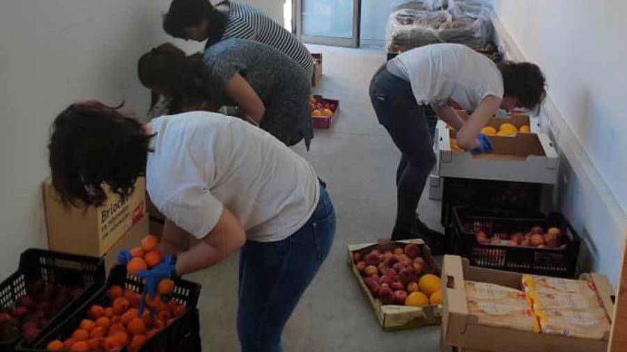 Voluntarias en un almacén de alimentos de Ames, desde donde distribuyen los víveres para desfavorecidos. Foto: CDA