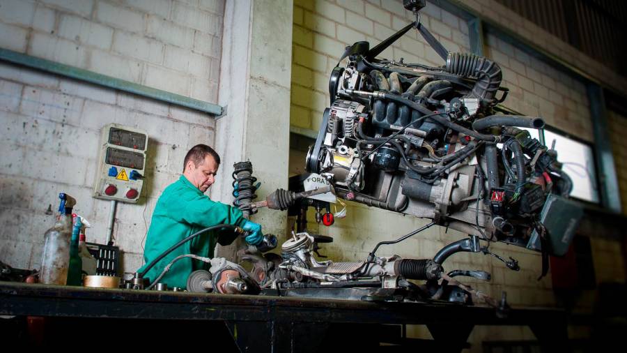Un empleado de Trameve, compostelano centro especial de empleo, trabaja con un motor. Foto: Diego Silva