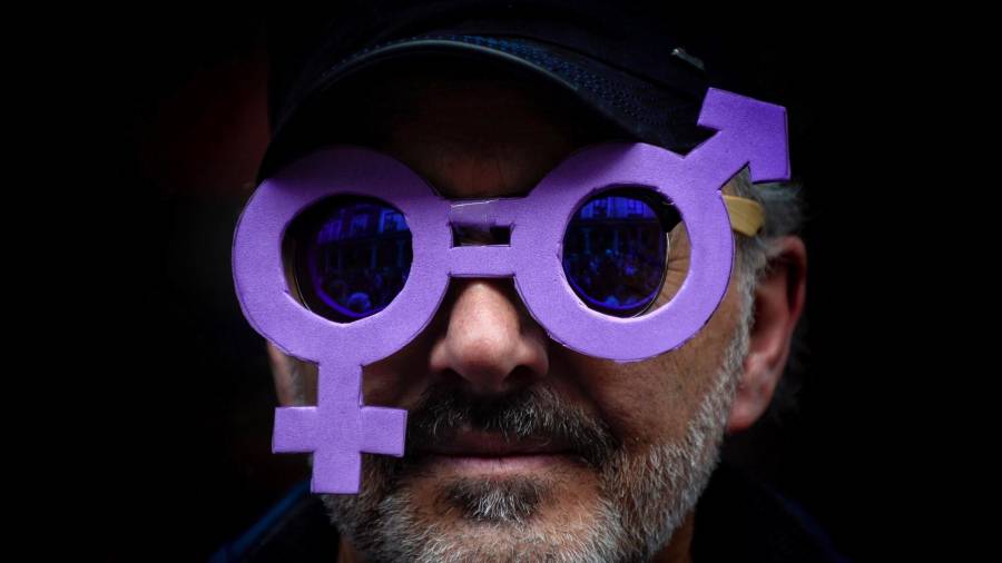Un hombre lleva unas gafas malvas, que representan la igualdad de géneros, durante la manifestación del 8 de marzo en Valladolid por el Día Internacional de la Mujer Trabajadora. (Autor, Nacho Gallego. Fuente, EFE)