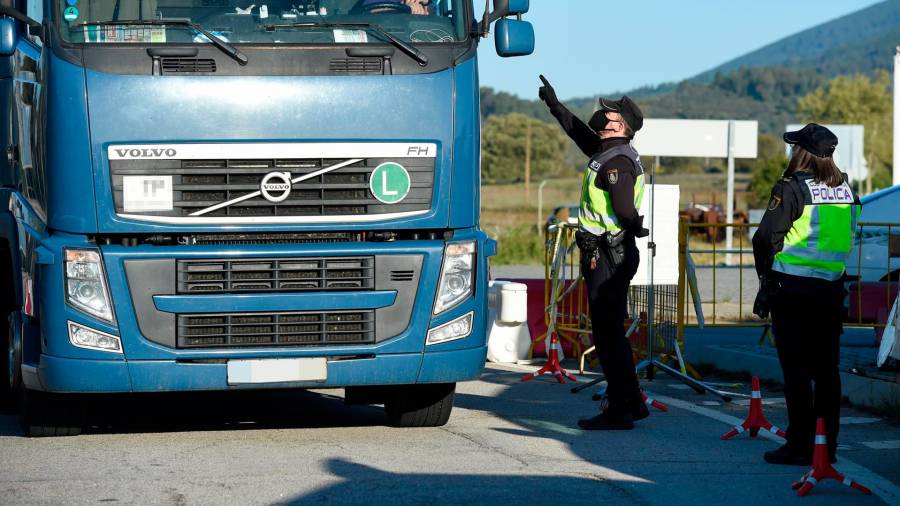 Un agente da el alto a un camión en un punto fronterizo entre España y Portugal. Foto: Gustavo Valiente / E.P.