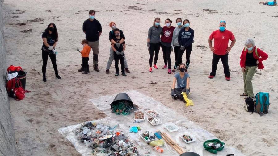 Voluntarios de una de las limpiezas promovidas por la entidad ecologista muestran la basura recogida. Foto: A.